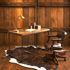 A rustic home office setup featuring a wooden desk with a black metal frame, a brown leather swivel office chair, and a cowhide rug on a hardwood floor against a wood-paneled wall.
