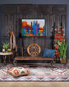 Rustic Western Pioneer Trails Bench with Wagon Wheel and Forged Iron Frame in room setting - Your Western Decor