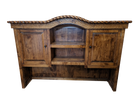 A rustic wooden hutch or sideboard cabinet with two paneled doors, two open shelves, and a decorative carved rope top edge, shown against a plain white background.