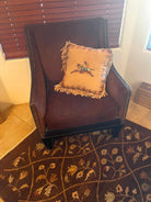 deer hide western accent pillow with cayuse pony artwork on brown accent chair 