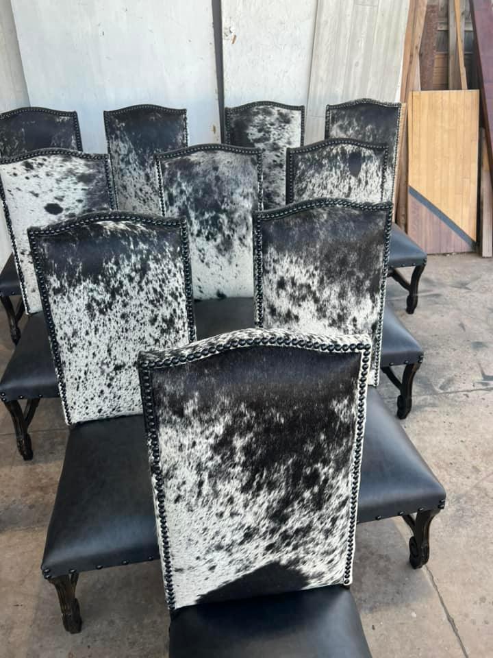 Western dining chairs upholstered in black leather and genuine peppered cowhide