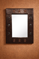 Decorative western mirror with star patterns on a brown textured wall - Your Western Decor