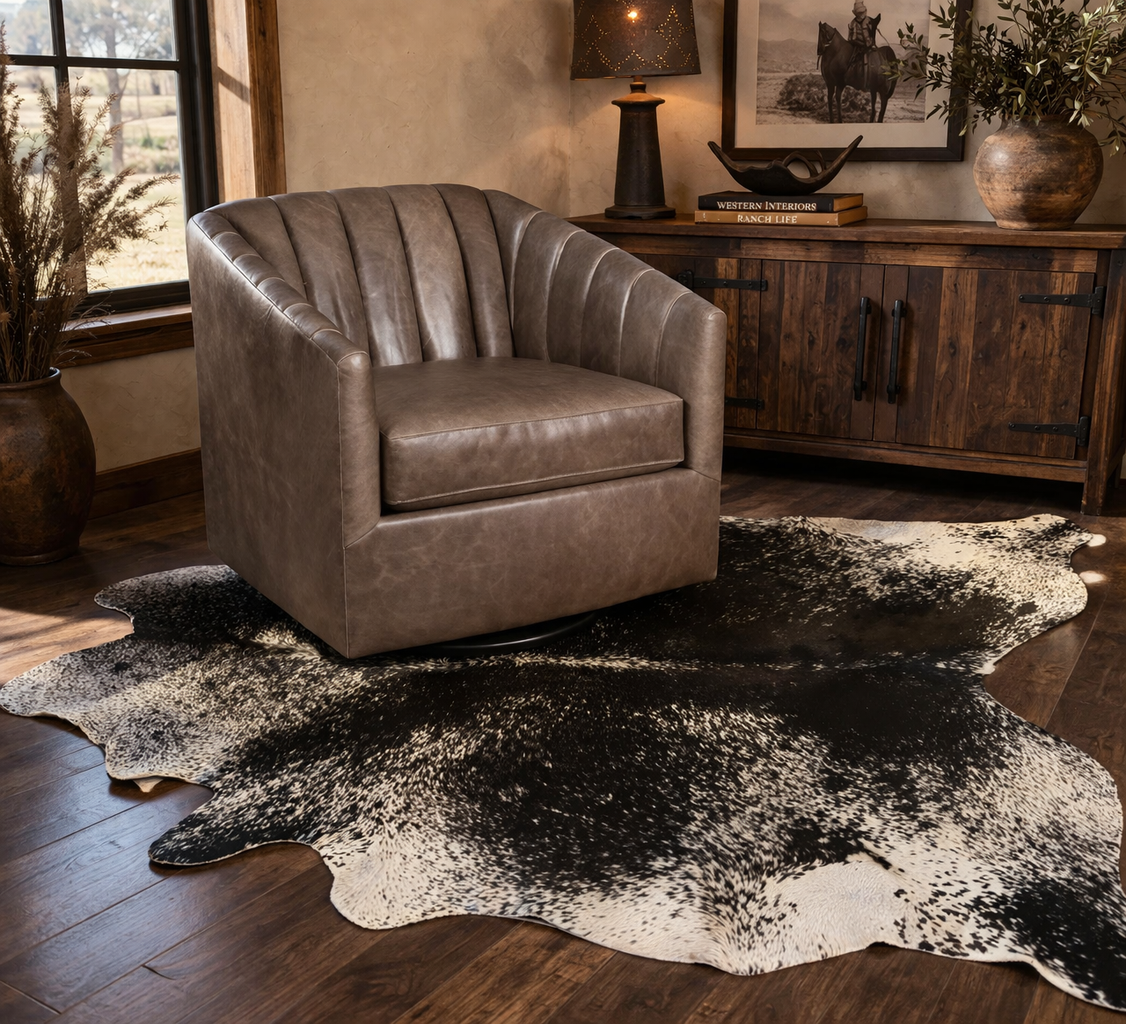 Western leather swivel chair on black and white cowhide rug in rustic ranch style living room with wood cabinet
