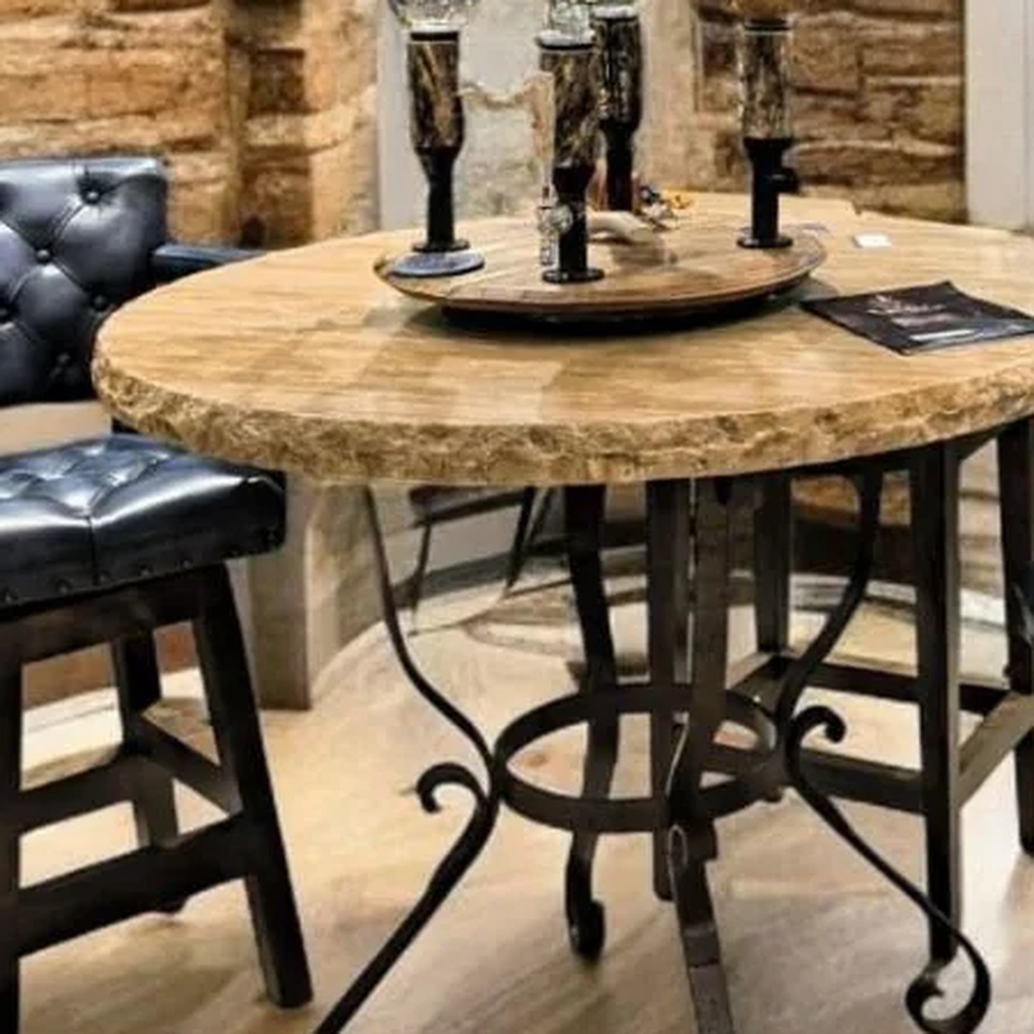 rustic travertine top bar height table with detailed edge and blue leather tufted barstools 