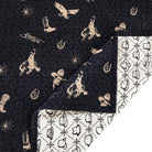 Black western quilt showing white western patterned reverse