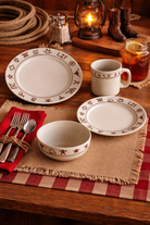 Western dining table setting with rustic plates, bowl, mug, and cutlery on a wooden table - Your Western Decor