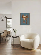 Modern living room with a white armchair, dining table, and western saddle art on the wall - Your Western Decor
