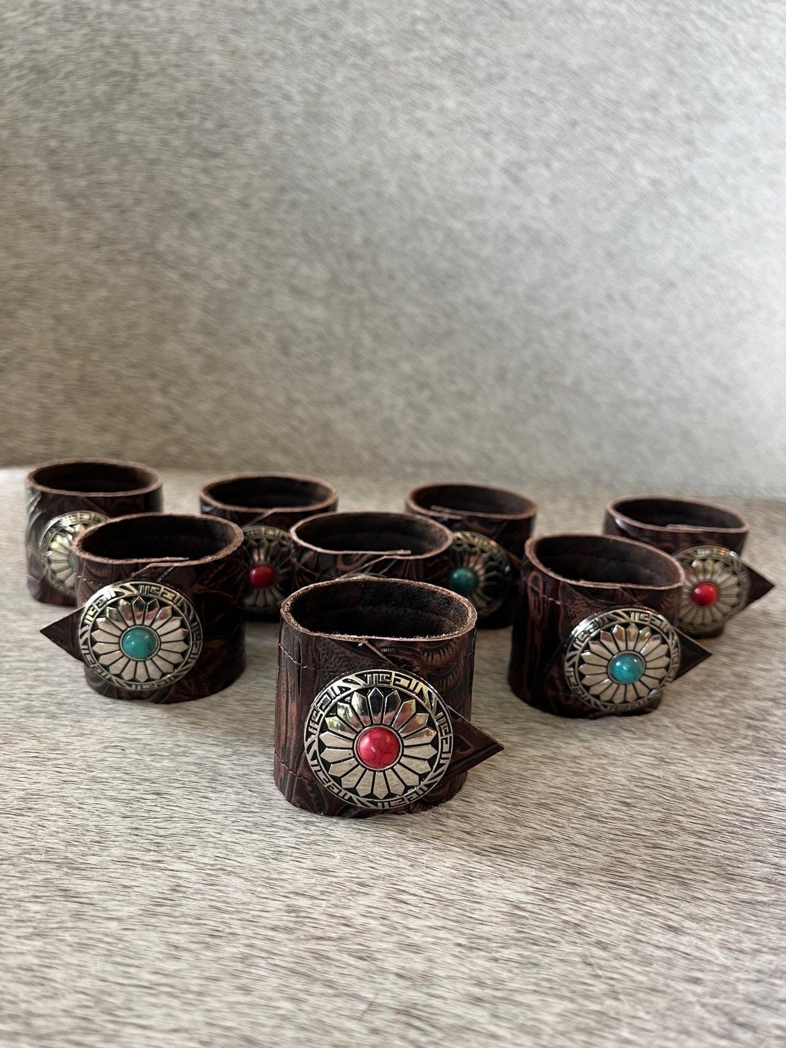 Western tooled leather napkin rings with decorative conchos handcrafted for cowboy table decor and ranch style dining table settings