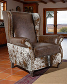 Brown leather armchair with cowhide pattern in a room with wooden floors and a window - Your Western Decor