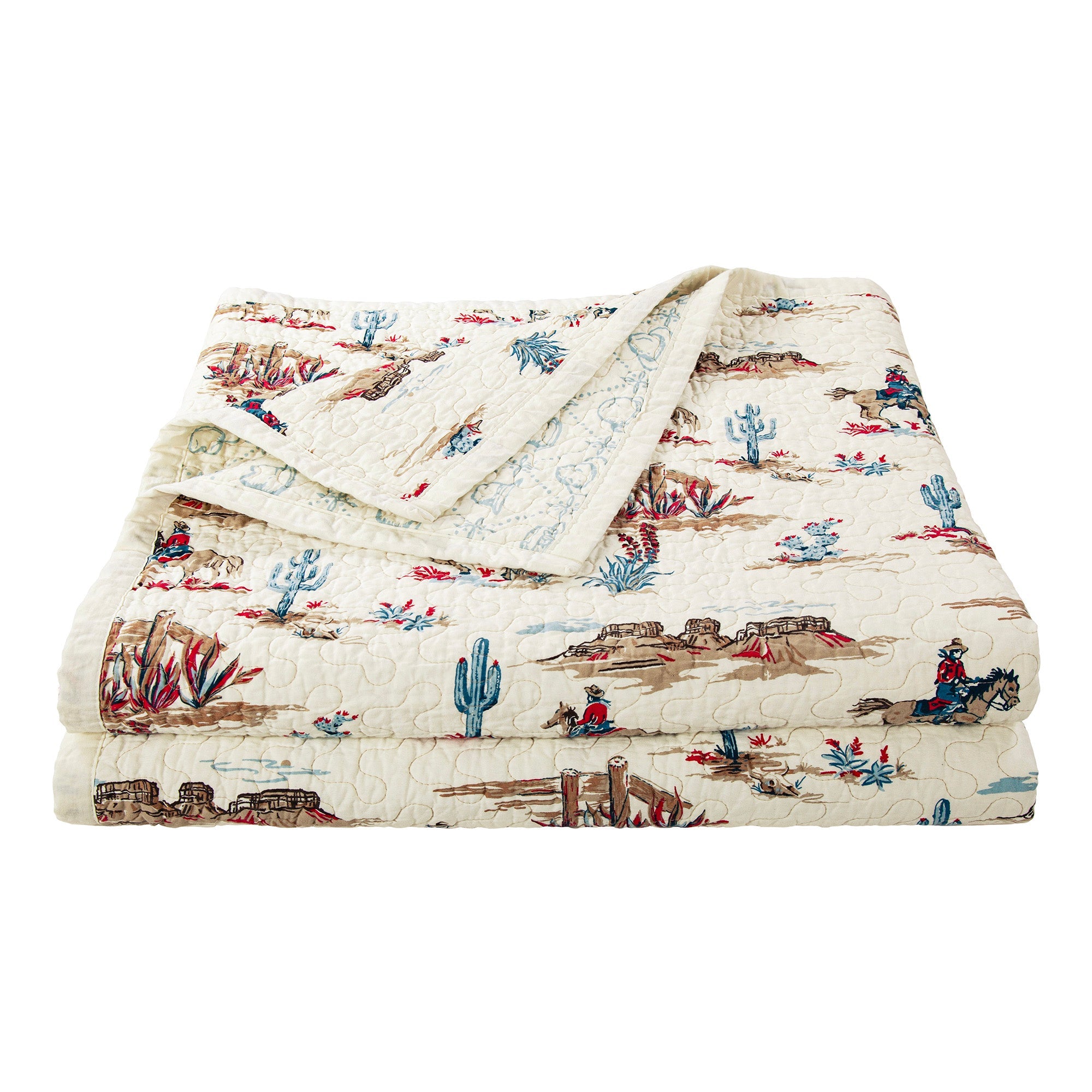 Quilt with desert-themed pattern featuring cacti, horses, and riders on a white background
