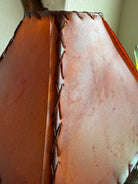 Detail of stitching on square amber rawhide lamp shade