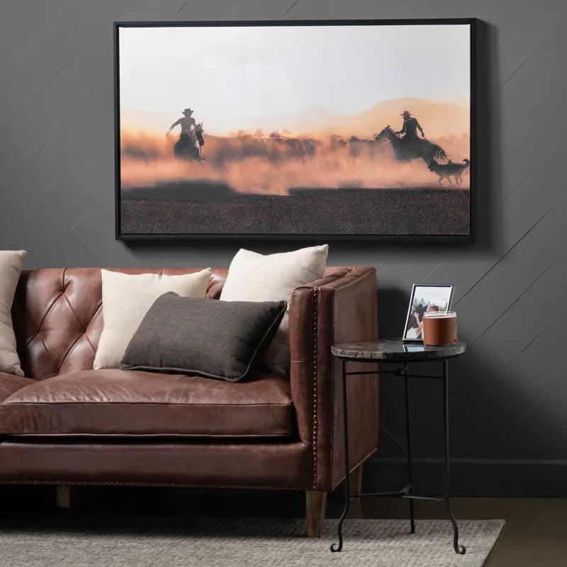 Working the Herd Western Art on wall above leather sofa - Your Western Decor