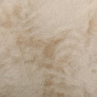 A close-up of a fluffy Yakety faux fur fabric  in a warm cream or off-white color, showing the soft texture and shaggy pile.