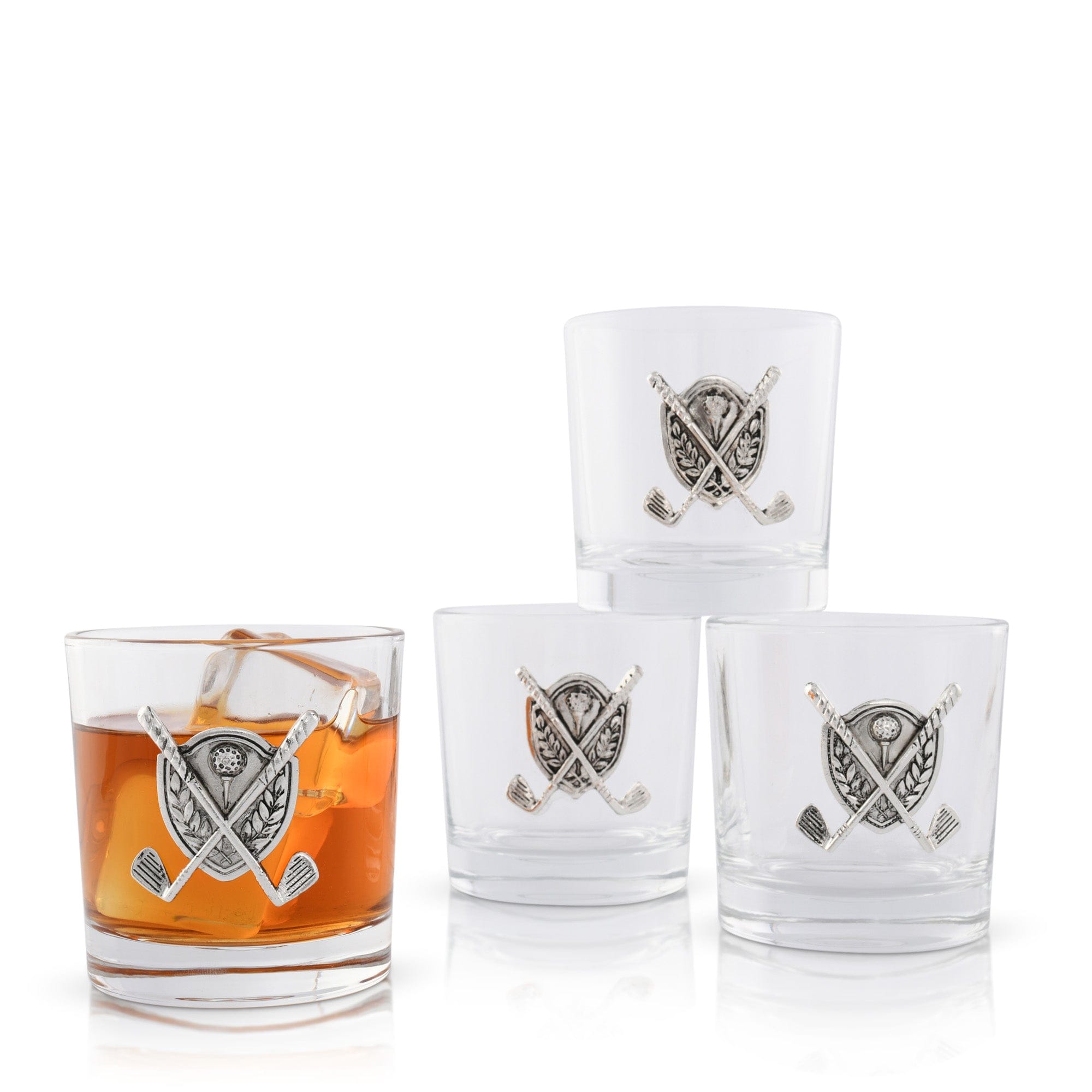 Set of four glass tumblers with decorative golf embellishments on a white background