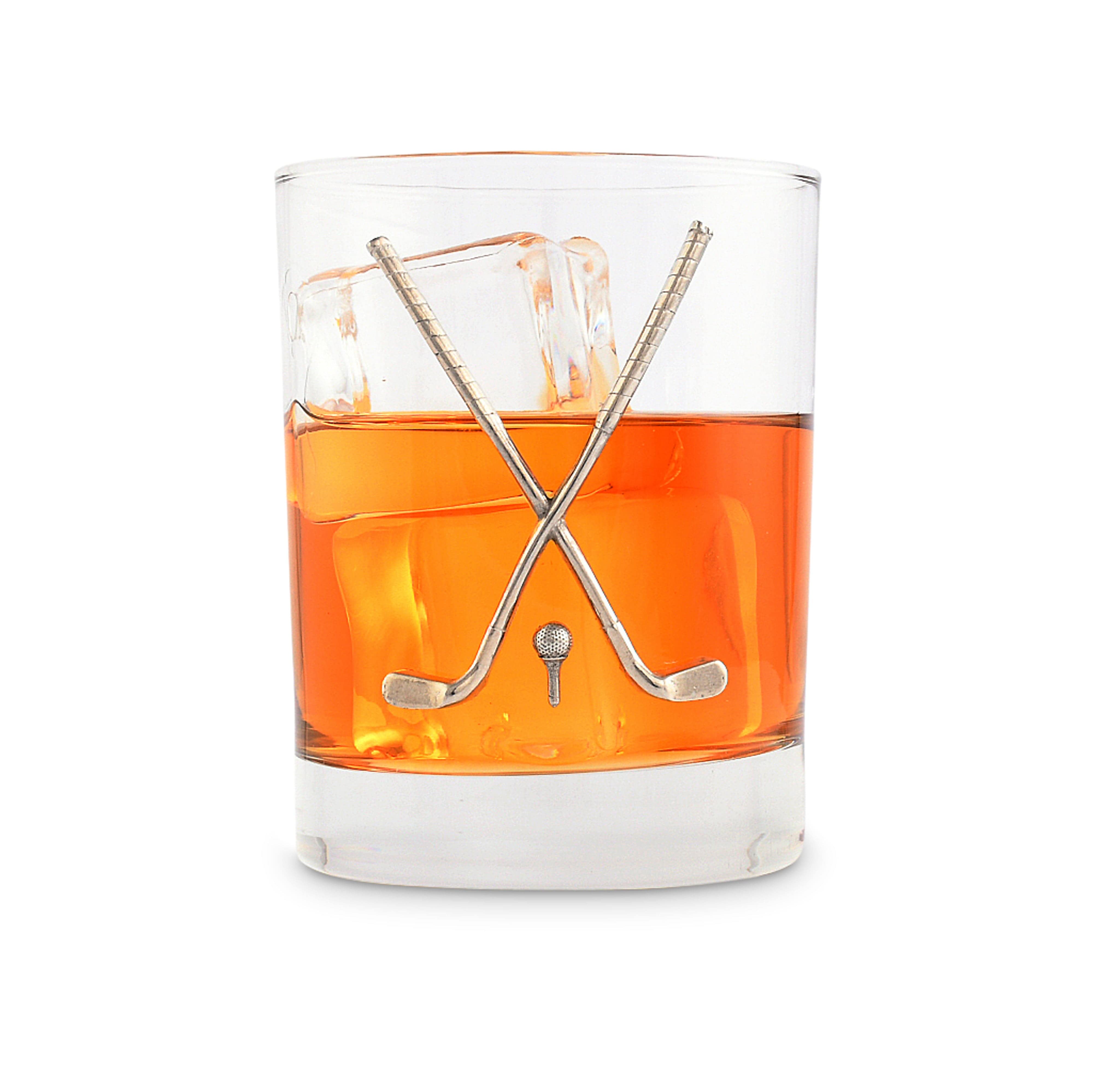 Clear glass with orange liquid and crossed hockey sticks on a white background