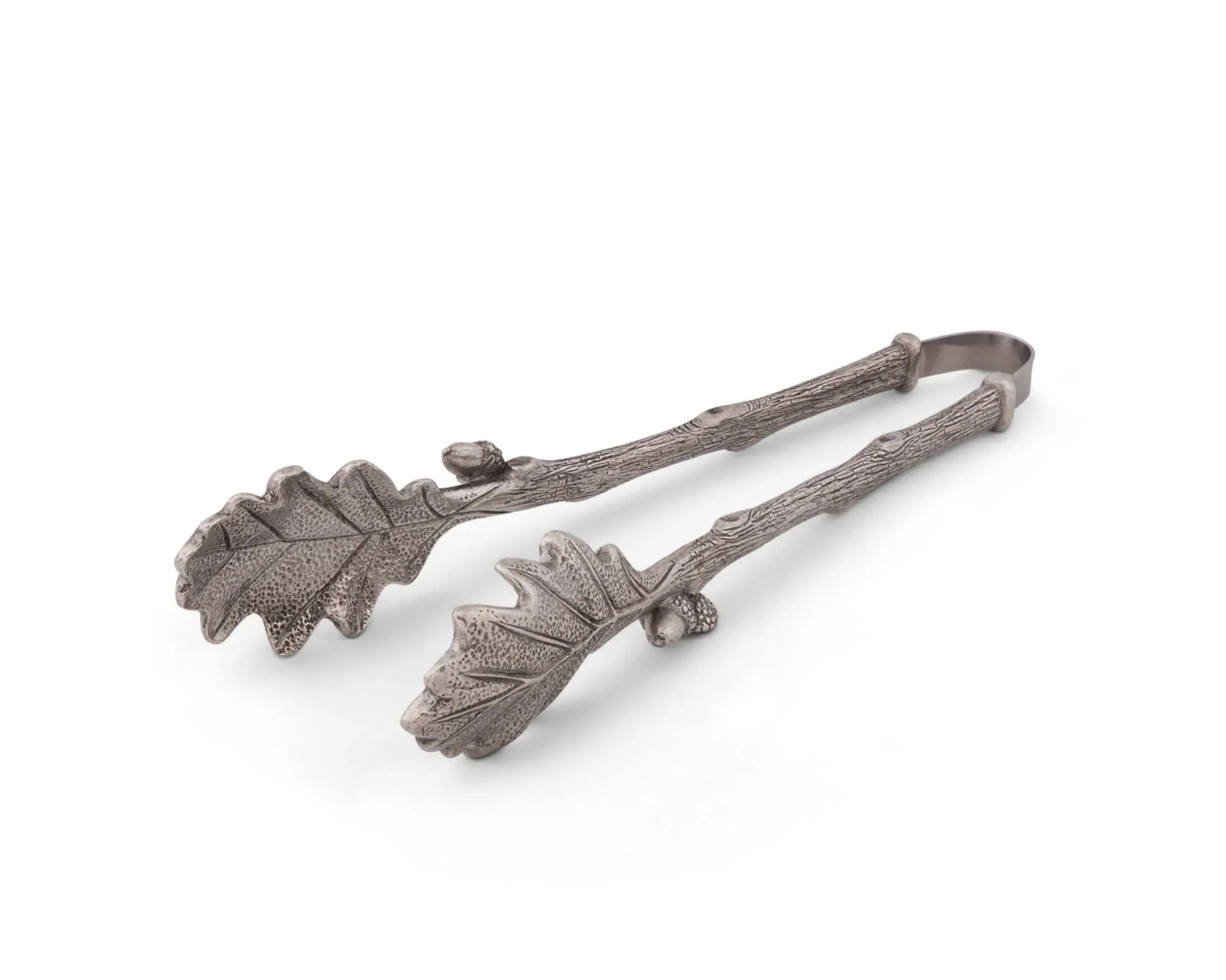Decorative tongs with leaf design on a white background