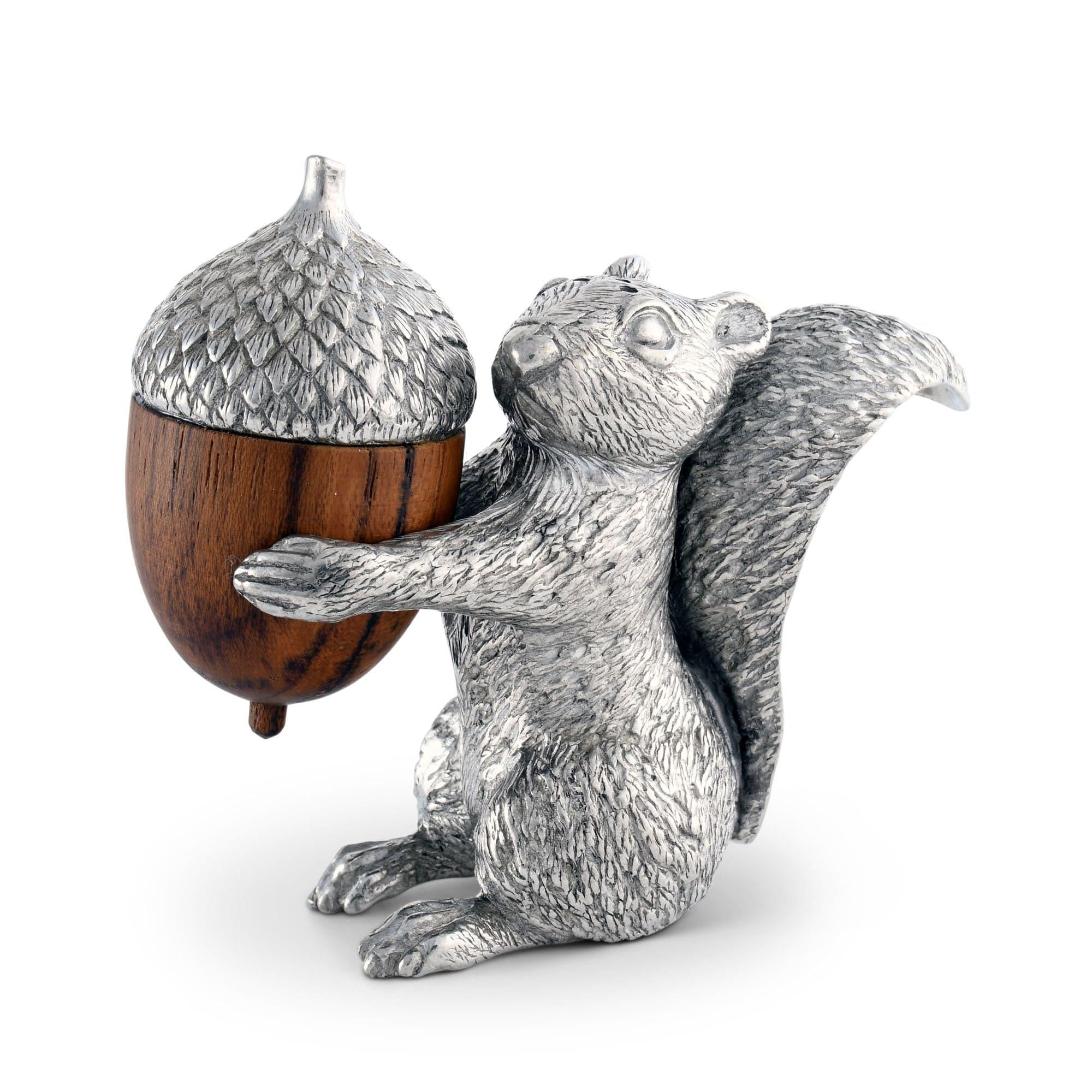 Pewter squirrel salt shaker figurine holding a wooden acorn on a white background