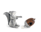Silver salt shaker squirrel figurine with a wooden pepper shaker acorn on a white background