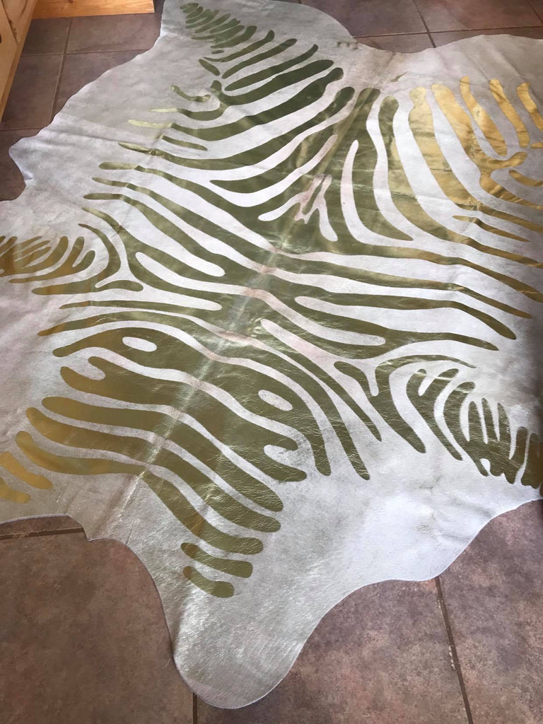 Gold stenciled zebra on beige cowhide rug - Your Western Décor & Design 