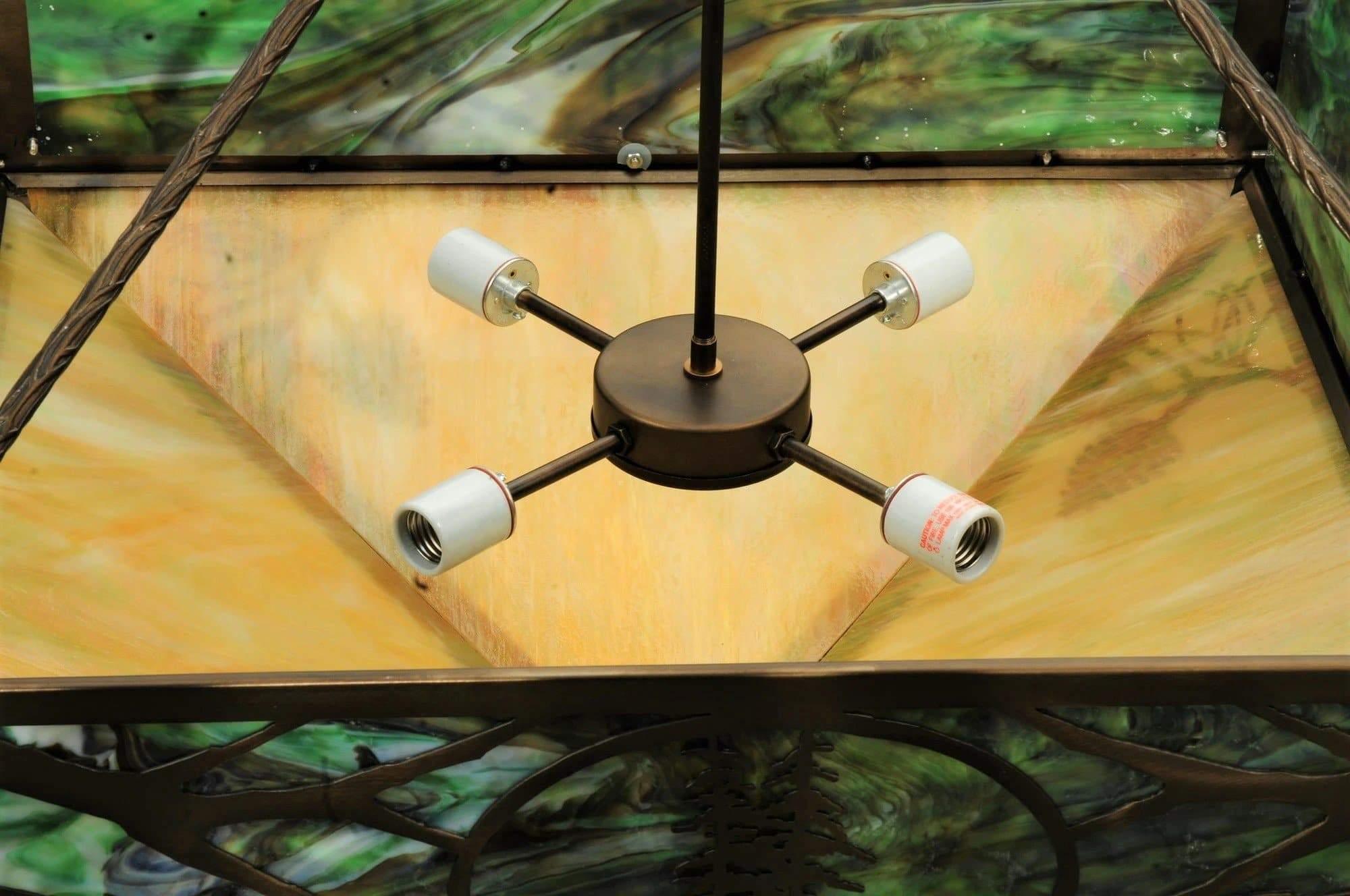 western lodge pendant light inside with antique copper finish and nature inspired stained glass design