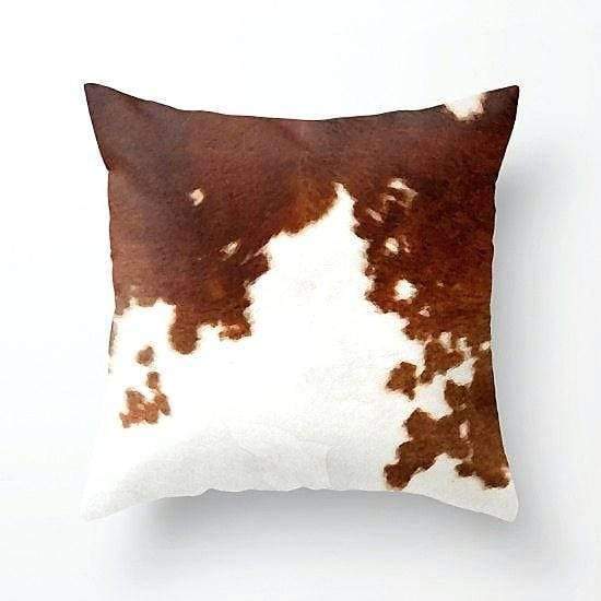 Brown and white cowhide throw pillow