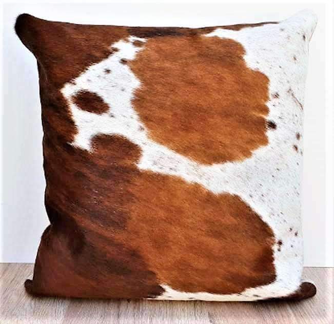 brown and white cowhide throw pillow 