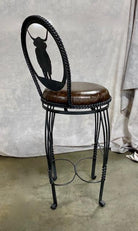 Side view of custom made iron frame swivel bar stool with Highlander cow cut-out on the back 
