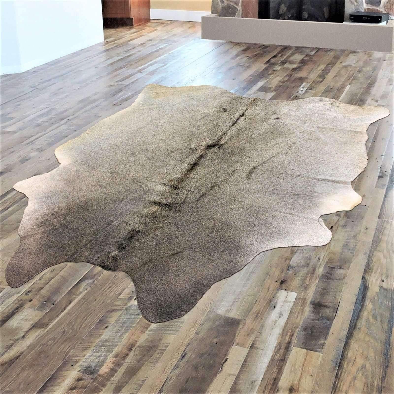 Natural grey cowhide rug with palomino tones for western living room or ranch style interior