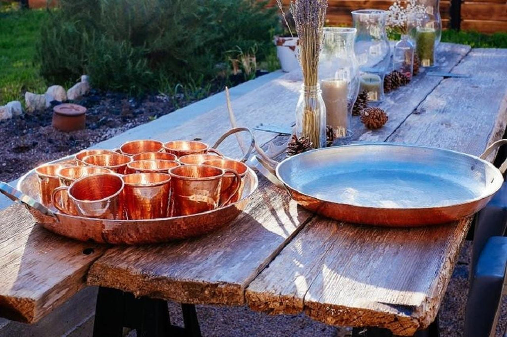 Hammered copper paella pans and Moscow Mule Copper Cups - Your Western Decor