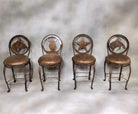 Custom made hand-forged iron counter swivel stools with various western cut-out backs and leather seats 