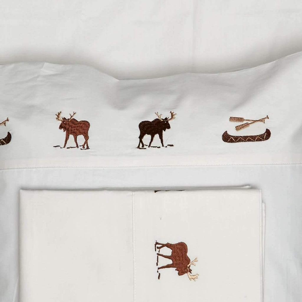Off-white sheet sets embroidered with moose and canoes. Your Western Decor