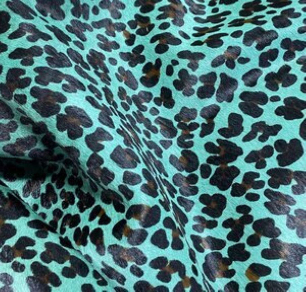 Stenciled Leopard on Turquoise Cowhide - Your Western Decor Upholstery and Design Studio