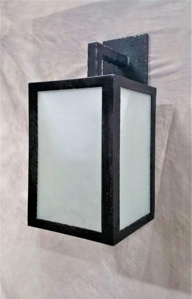 Rustic coastal wall sconce. Black iron and frosted glass. Your Western Decor